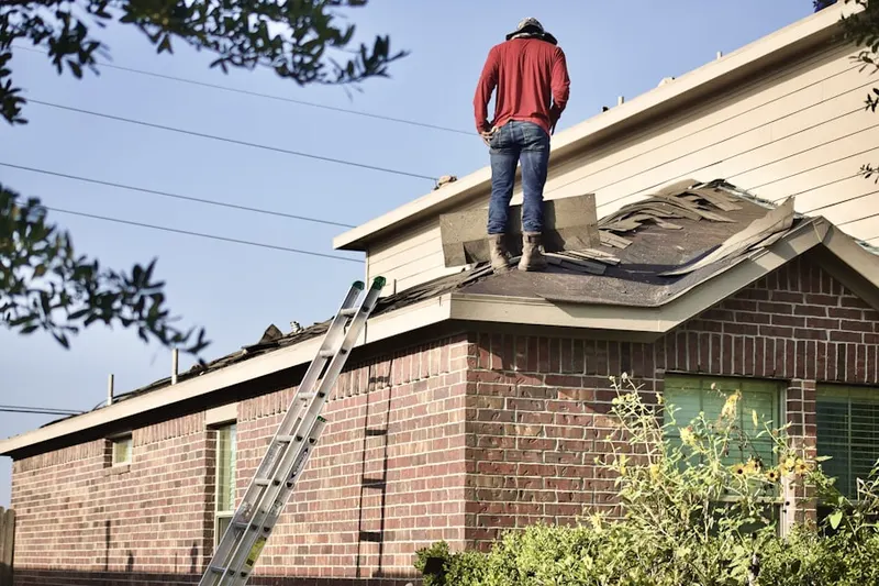 Professional roofer working on a residential roof in Cambria